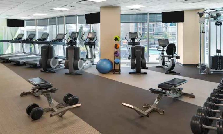 Fully equipped fitness center with treadmills and weights at the Hilton Vancouver Downtown.