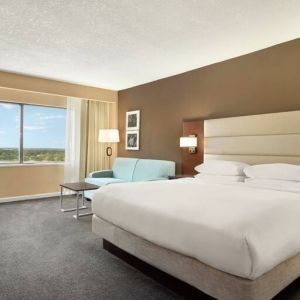 Oversized king room with sofa bed, dining and living Area at the DoubleTree by Hilton Orlando Downtown.