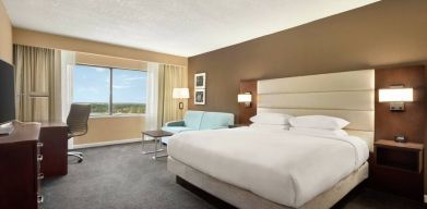 Oversized king room with sofa bed, dining and living Area at the DoubleTree by Hilton Orlando Downtown.