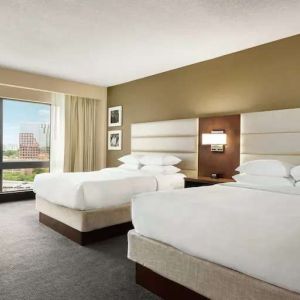 2 queen size beds in a bright room with TV screen and great view at the DoubleTree by Hilton Orlando Downtown.