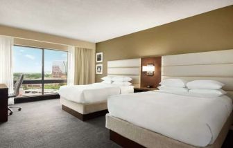 2 queen size beds in a bright room with TV screen and great view at the DoubleTree by Hilton Orlando Downtown.