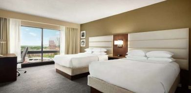 2 queen size beds in a bright room with TV screen and great view at the DoubleTree by Hilton Orlando Downtown.