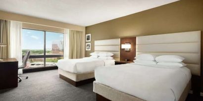 2 queen size beds in a bright room with TV screen and great view at the DoubleTree by Hilton Orlando Downtown.