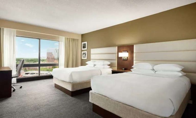 2 queen size beds in a bright room with TV screen and great view at the DoubleTree by Hilton Orlando Downtown.