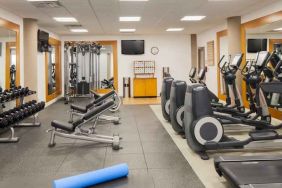 Fitness center with treadmill, exercising bike and weights at the DoubleTree by Hilton Orlando Downtown.