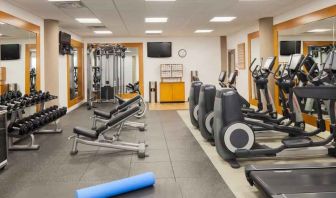 Fitness center with treadmill, exercising bike and weights at the DoubleTree by Hilton Orlando Downtown.