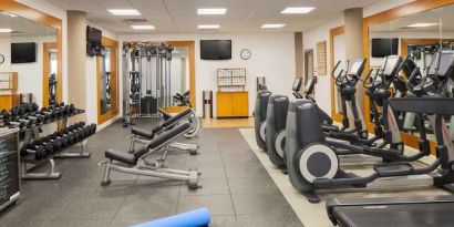 Fitness center with treadmill, exercising bike and weights at the DoubleTree by Hilton Orlando Downtown.