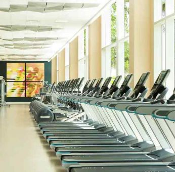 Fully equipped fitness center with treadmills and weights at the Hilton Orlando.