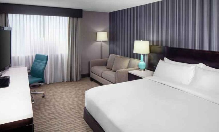 Spacious king size bed room with desk, tv and bath at the DoubleTree by Hilton Cleveland Westlake.