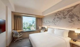 King size bed in a deluxe room with great city view at the Hilton Garden Inn Singapore Serangoon.