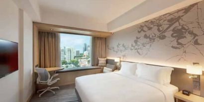 King size bed in a deluxe room with great city view at the Hilton Garden Inn Singapore Serangoon.