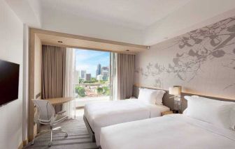 Deluxe twin bedroom with balcony for a great city view at the Hilton Garden Inn Singapore Serangoon.