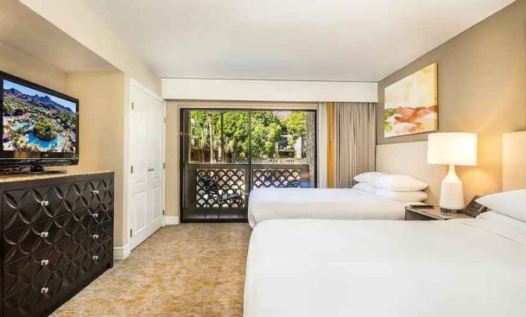 Bright and comfortable bedroom with 2 queen size beds, TV screen and window at the Hilton Phoenix Resort at the Peak