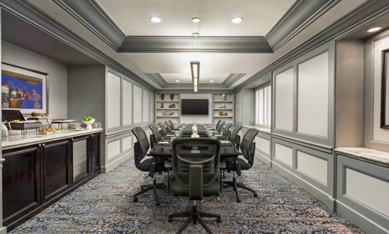 Classy conference room with crown molding, presentor flatscreen TV and seating for 10.