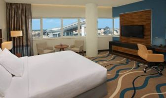 King size bed with 42 inch tv, minibar, and bathroom