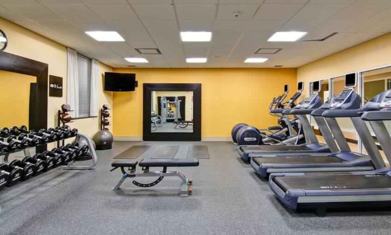 Fully equipped fitness center with treadmills and weights at the Hampton Inn by Hilton Toronto Airport Corporate Centre.