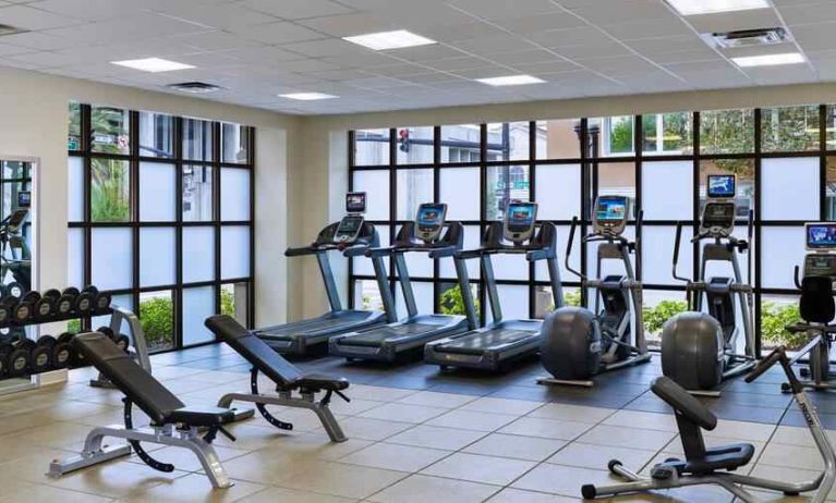 Fitness center with treadmills and weights at the Embassy Suites by Hilton Orlando-Downtown.