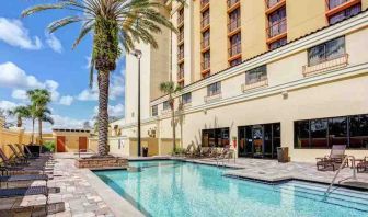 Relaxing outdoor pool area with at the Embassy Suites by Hilton Orlando-International Drive Convention Center.