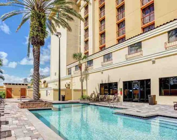 Relaxing outdoor pool area with at the Embassy Suites by Hilton Orlando-International Drive Convention Center.