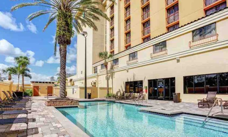 Relaxing outdoor pool area with at the Embassy Suites by Hilton Orlando-International Drive Convention Center.