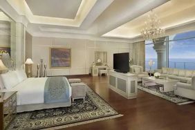 Deluxe suite with separate living room and sea view at the Waldorf Astoria Dubai Palm Jumeirah.