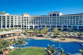 Beautiful outdoors with garden and pool at the Waldorf Astoria Dubai Palm Jumeirah.