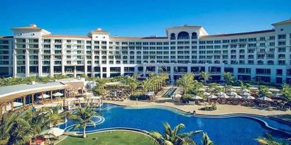 Beautiful outdoors with garden and pool at the Waldorf Astoria Dubai Palm Jumeirah.