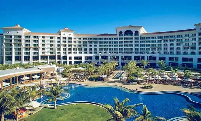 Beautiful outdoors with garden and pool at the Waldorf Astoria Dubai Palm Jumeirah.