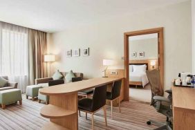 King bedroom suite with living room, sofa bed and working station at the Hilton Garden Inn Dubai Mall of the Emirates.