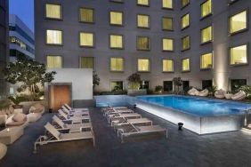 Relaxing outdoor pool area at the Hilton Garden Inn Dubai Mall of the Emirates.