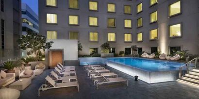 Relaxing outdoor pool area at the Hilton Garden Inn Dubai Mall of the Emirates.