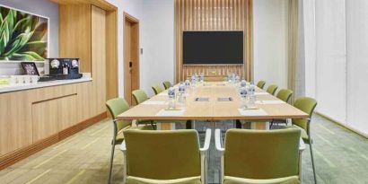 Meeting room with square conference table at the Hilton Garden Inn Dubai Mall of the Emirates.