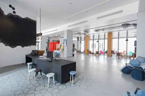 Spacious working station with desks and computers at the Hampton by Hilton Dubai Al Seef.