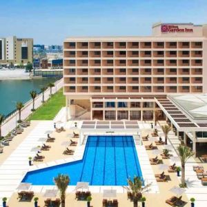 Relaxing outdoor pool area with outstanding creek view at the Hilton Ras Al Khaimah Beach Resort.