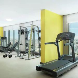 Spacious gym with workout equipment and large windows