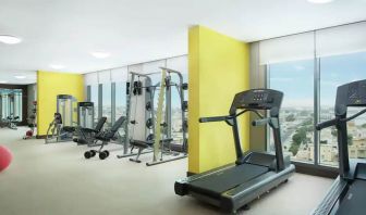 Spacious gym with workout equipment and large windows