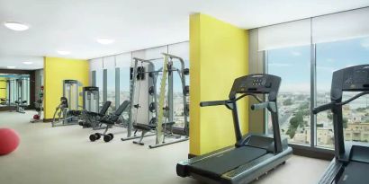 Spacious gym with workout equipment and large windows