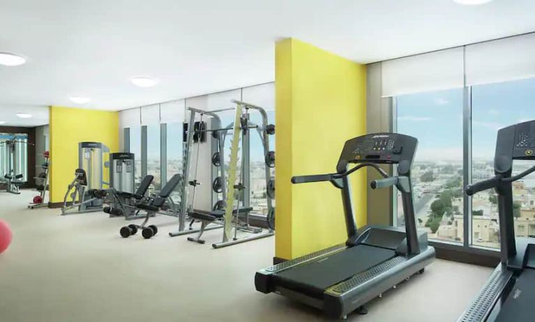 Spacious gym with workout equipment and large windows