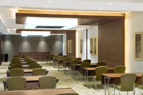 Large meeting room and workspace with multiple chairs and desks at the Hilton Garden Inn Dubai Al Muraqabat