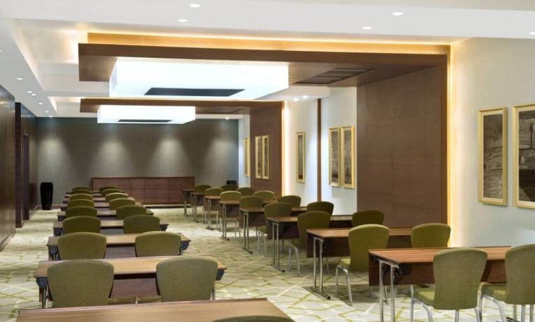 Large meeting room and workspace with multiple chairs and desks at the Hilton Garden Inn Dubai Al Muraqabat