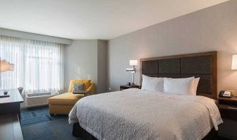 Spacious, king bed with natural light at Hampton Inn Chicago North-Loyola Station.