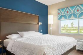 King-sized room with natural light at Tru by Hilton Milwaukee Brookfield.