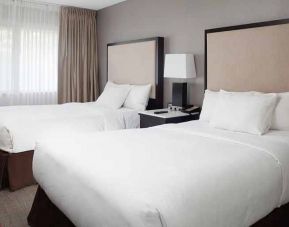 2 double beds in comfortable, well lit room at DoubleTree Suites by Hilton Hotel Dayton - Miamisburg.