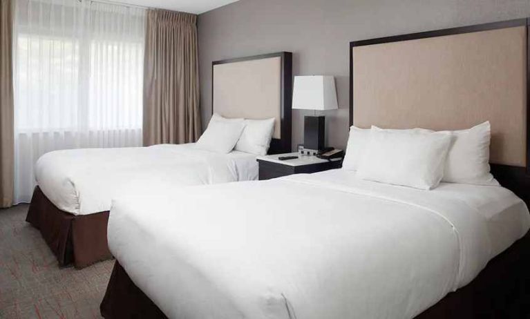 2 double beds in comfortable, well lit room at DoubleTree Suites by Hilton Hotel Dayton - Miamisburg.