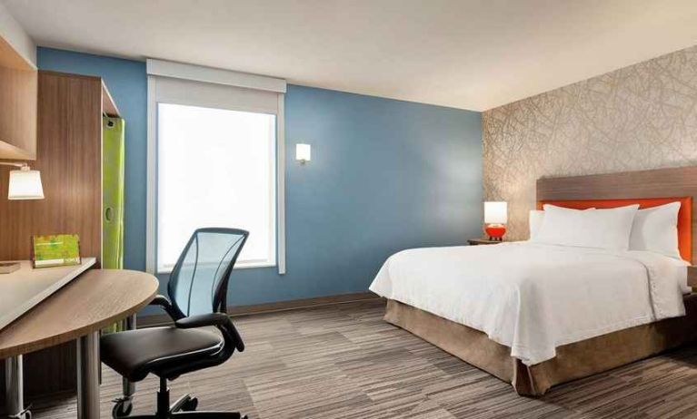 Comfortable king-sized-bed with dedicated workspace at Home2 Suites by Hilton Silver Spring.