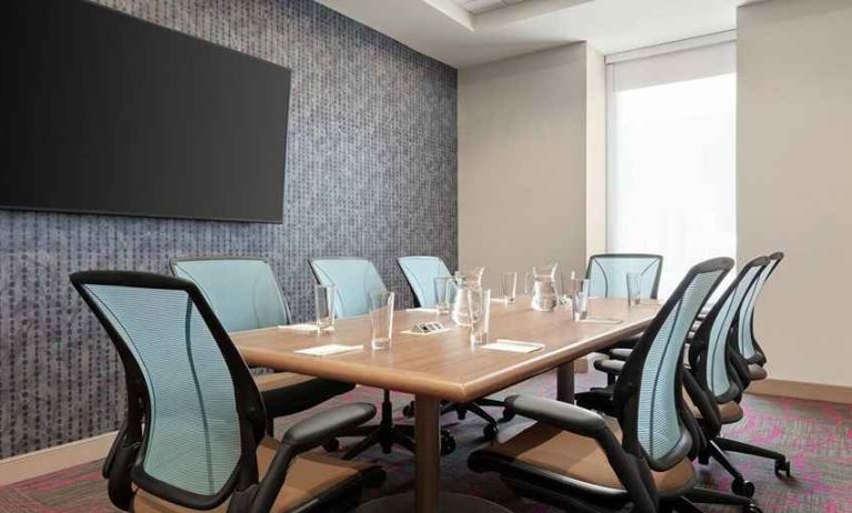 Small, professional meeting room at Home2 Suites by Hilton Silver Spring.