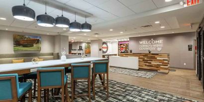 Spacious and comfortable lobby area perfect as workspace at the Hampton Inn Madison, OH.