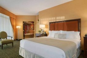 Spacious 2 bedroom suite with a king size bed, desk, tv, and bath at the Embassy Suites by Hilton Hampton Convention Center