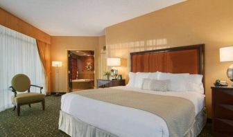 Spacious 2 bedroom suite with a king size bed, desk, tv, and bath at the Embassy Suites by Hilton Hampton Convention Center