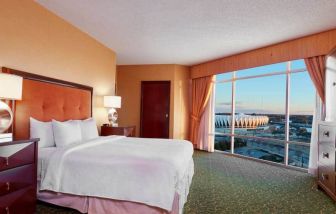 Spacious king bed room with a view, tv, activity table and bath at the Embassy Suites by Hilton Hampton Convention Center